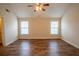 Bright bedroom with wood-look floors, a ceiling fan, and two windows for ample light at 4135 Arch Pass, Cumming, GA 30040