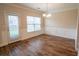 Dining area featuring wood floors, modern wainscoting, and a stylish light fixture at 4135 Arch Pass, Cumming, GA 30040