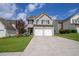 Inviting two-story home with a two-car garage, blue accents and a well-manicured lawn at 4135 Arch Pass, Cumming, GA 30040