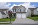 Inviting two-story home with a two-car garage, blue accents and a well-manicured lawn at 4135 Arch Pass, Cumming, GA 30040