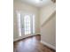 Inviting foyer featuring hardwood floors, a staircase, and a bright white door at 4135 Arch Pass, Cumming, GA 30040