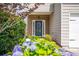 Charming front entrance with a blue door, brick accents, and lush hydrangea bushes at 4135 Arch Pass, Cumming, GA 30040