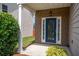 Inviting front door with brick accents and colorful landscaping at 4135 Arch Pass, Cumming, GA 30040