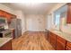 This kitchen features stainless steel appliances, granite countertops, and hardwood flooring at 4135 Arch Pass, Cumming, GA 30040