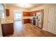 This kitchen features stainless steel appliances, wooden cabinets, and hardwood flooring at 4135 Arch Pass, Cumming, GA 30040