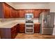 Stylish kitchen with granite counters, stainless appliances, and wood-look flooring at 4135 Arch Pass, Cumming, GA 30040