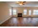 Spacious living room with fireplace, modern flooring, and lots of natural light at 4135 Arch Pass, Cumming, GA 30040