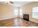 Bright living room featuring a fireplace, neutral walls, and wood-look flooring at 4135 Arch Pass, Cumming, GA 30040