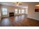 Spacious living room with fireplace, modern flooring, and lots of natural light at 4135 Arch Pass, Cumming, GA 30040