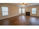 Spacious living room with wood floors, a ceiling fan, and a fireplace at 4135 Arch Pass, Cumming, GA 30040