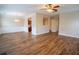 Open floor plan combines living and dining areas with wood floors and natural light at 4135 Arch Pass, Cumming, GA 30040