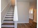 Elegant staircase with wood steps and white risers, complemented by wood floors and neutral wall colors at 4135 Arch Pass, Cumming, GA 30040