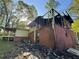 Damaged building exterior with charred remains, burnt siding, and visible structural damage after fire at 447 Martindale Ct, Stone Mountain, GA 30088