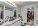 Spacious bathroom with dual sinks, granite countertops, and a walk-in closet for ample storage at 510 Abeer St, Temple, GA 30179