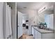 Bright bathroom featuring granite countertops, a shower with curtain, and a doorway to the bedroom at 510 Abeer St, Temple, GA 30179