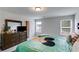 Comfortable bedroom with a large dresser, plush carpet, and ample natural light from two windows at 510 Abeer St, Temple, GA 30179