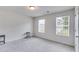 Bedroom with neutral walls and carpet, two large windows and a side table at 510 Abeer St, Temple, GA 30179