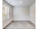 Light-filled bedroom featuring wood-look floors, neutral walls, and a large window at 510 Abeer St, Temple, GA 30179