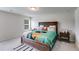 Cozy bedroom featuring a rustic wooden bed frame, plush carpet, and bright natural light at 510 Abeer St, Temple, GA 30179