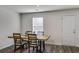 Bright dining room with modern table with seating for four, window, and door to outside at 510 Abeer St, Temple, GA 30179