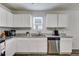 Modern kitchen featuring white cabinets, stainless steel appliances, and granite countertops at 510 Abeer St, Temple, GA 30179