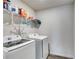 Efficient laundry room with modern appliances and convenient overhead shelving for storage at 510 Abeer St, Temple, GA 30179