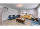 Bright living room with wood-look floors and modern furnishings, including blue and yellow couches at 510 Abeer St, Temple, GA 30179