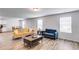 Open-concept living room with wood-look floors and modern furniture at 510 Abeer St, Temple, GA 30179