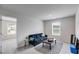 Cozy living room features neutral walls, black sofa, side table, and large window at 510 Abeer St, Temple, GA 30179
