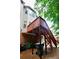 View of home's backyard with elevated deck and stairs to upper level at 5996 Eagle Tiff Ln, Sugar Hill, GA 30518