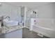 Modern bathroom with soaking tub, glass shower, and sleek vanity at 5996 Eagle Tiff Ln, Sugar Hill, GA 30518