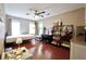Bright bedroom featuring hardwood floors, a ceiling fan, and well-lit vanity with shelving at 5996 Eagle Tiff Ln, Sugar Hill, GA 30518