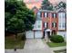 Attractive brick townhouse with a two-car garage, well-maintained landscaping, and ample parking space at 5996 Eagle Tiff Ln, Sugar Hill, GA 30518