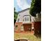 Back exterior showcasing brick facade, siding, and bay window at 5996 Eagle Tiff Ln, Sugar Hill, GA 30518