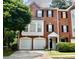 Charming brick townhouse with a two-car garage, well-maintained landscaping, and a welcoming entrance at 5996 Eagle Tiff Ln, Sugar Hill, GA 30518