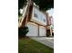 Exterior view of a brick townhouse with a two-car garage and well-maintained landscaping at 5996 Eagle Tiff Ln, Sugar Hill, GA 30518