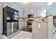 Modern kitchen featuring stainless steel appliances, granite countertops, and ample cabinetry at 5996 Eagle Tiff Ln, Sugar Hill, GA 30518