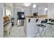 Bright and open kitchen with granite counters, stainless steel appliances, and bar seating at 5996 Eagle Tiff Ln, Sugar Hill, GA 30518
