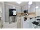 Bright kitchen features granite countertops, stainless steel appliances, and breakfast bar at 5996 Eagle Tiff Ln, Sugar Hill, GA 30518