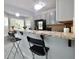 Bright kitchen with stainless appliances, granite counters, and breakfast bar seating at 5996 Eagle Tiff Ln, Sugar Hill, GA 30518
