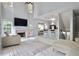 Bright open-concept living room features fireplace and access to eat-in kitchen bar at 5996 Eagle Tiff Ln, Sugar Hill, GA 30518