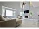 Spacious living room with high ceilings, fireplace, and wall to wall windows at 5996 Eagle Tiff Ln, Sugar Hill, GA 30518