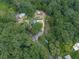 Aerial view of a home surrounded by trees featuring outbuildings and driveway at 776 Green Dr, Canton, GA 30114