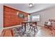 Dining room with wood-paneled accent wall, table with chairs, and wood flooring at 776 Green Dr, Canton, GA 30114