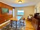 Dining room featuring wood paneled walls, wood floors, a vintage table set and rocking chair at 776 Green Dr, Canton, GA 30114