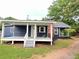 Charming single-story home featuring a covered front porch and a red brick chimney at 776 Green Dr, Canton, GA 30114