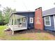 Back porch with a grill, chimney, and blue siding gives this home a charming, outdoor living space at 776 Green Dr, Canton, GA 30114