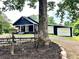 Exterior view of the home with a charming front yard and detached garage, showing rural appeal at 776 Green Dr, Canton, GA 30114
