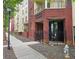 Brick exterior building entrance with black metal gated door and sidewalk with mature tree in view at 870 Mayson Turner Rd # 1207, Atlanta, GA 30314