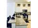 Open kitchen featuring granite countertops, modern stainless-steel appliances, and breakfast bar seating at 870 Mayson Turner Rd # 1207, Atlanta, GA 30314